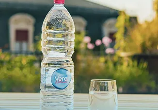 Bottle of Acqua Vera on an outdoor table