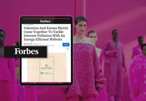 Forbes article on Valentino and Karma Metrix on a tablet, with a Valentino fashion show in the background